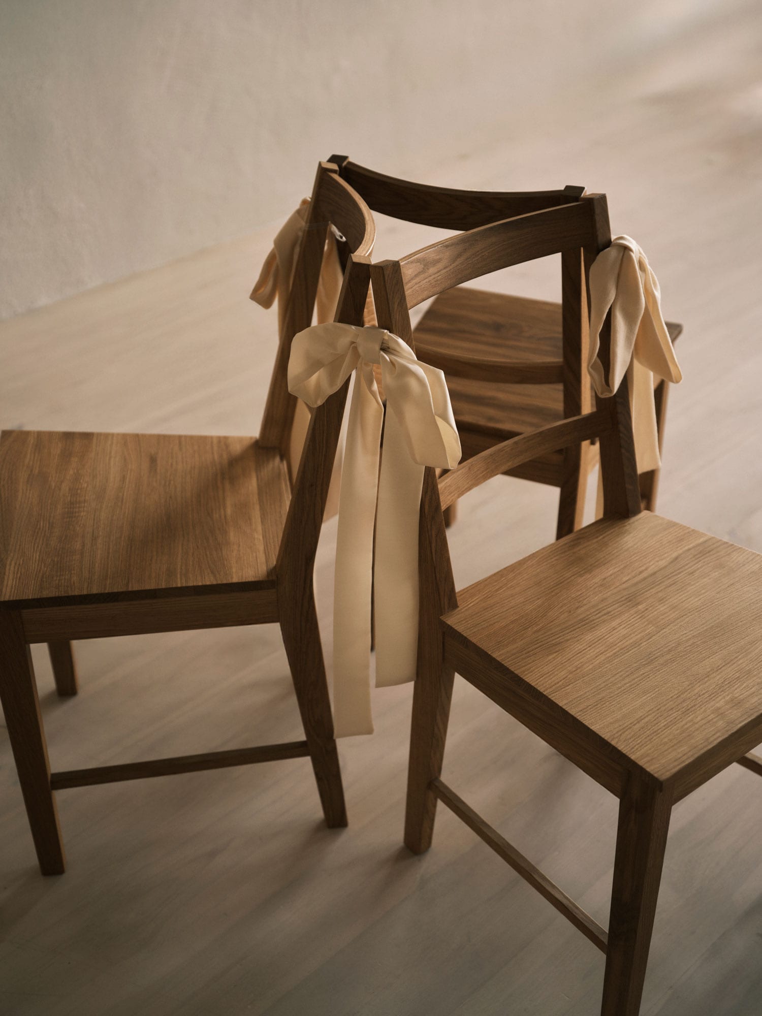 three chairs in a circle with ribbons