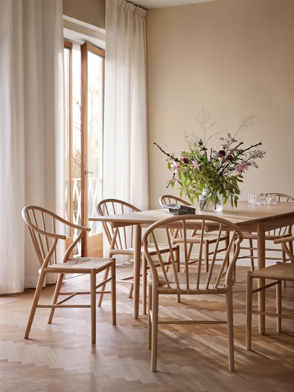Dining room with chairs and table with a large flower bouquet on the table