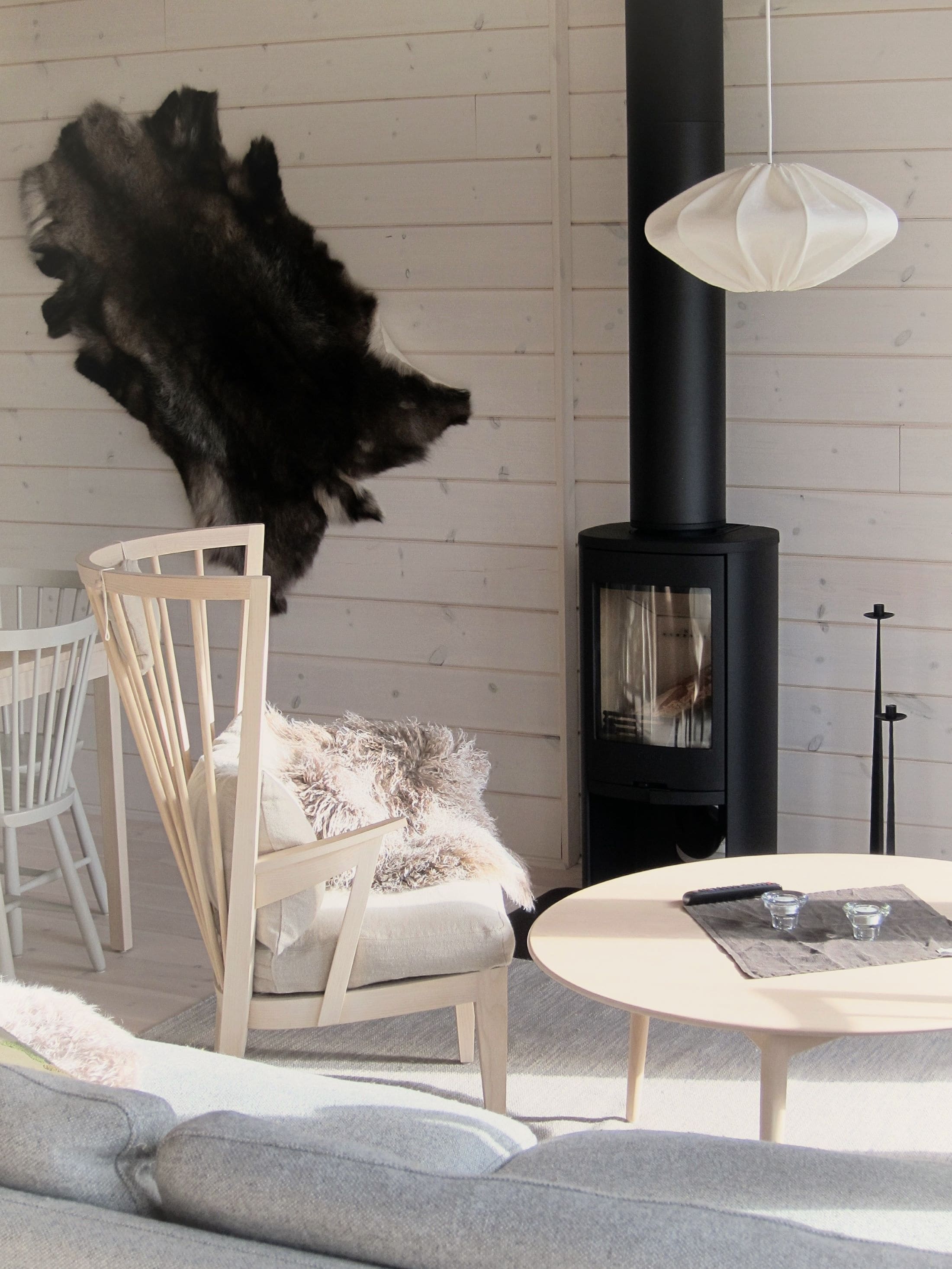 wooden armchair and coffee table in front of an open fireplace